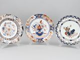three plates with different designs on them sitting on a table