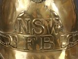 a gold bell with the words niswe f b on it