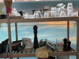 a shelf with a lot of dishes and utensils on it