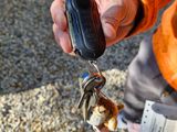 a person holding a car key in their hand