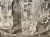 four glasses sitting on a tray on a table