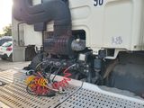 a truck with a bunch of wires attached to the back of it
