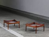 two small wooden tables sitting on the floor next to each other