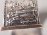 a close up of a silver ring with a picture on it