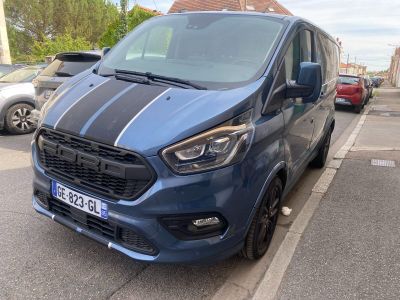 a blue van that is parked on the side of the street