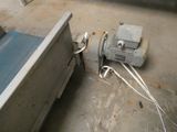 a machine that is sitting on the floor next to a bed