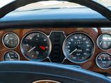 a steering wheel and gauges in the dashboard of a car