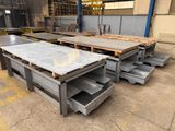 some steel steel plates are stacked on top of each other in a warehouse