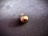 a gold christmas ornament on a purple blanket