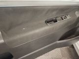 the interior of a car with the door open and the driver ' s seat down