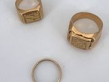 two gold rings and a gold ring with a ring in the middle
