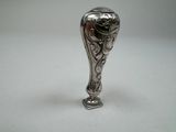 a silver vase that is sitting on a table
