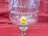 a glass cup with a yellow sticker on it