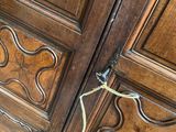 a large wooden cabinet with a bunch of wood panels on it