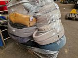 a pile of mattresses wrapped in plastic in a warehouse