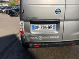 a silver van that is parked in a parking lot