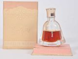 an image of a bottle of perfume sitting next to a box