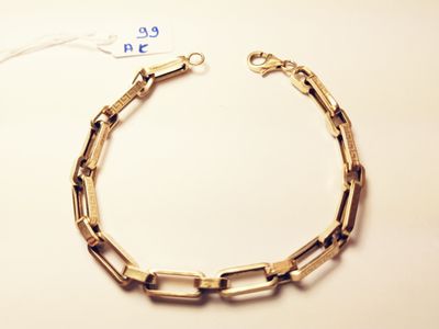 a close up of a chain bracelet with a tag on it