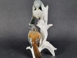 porcelain figurine of two birds perched on a tree branch