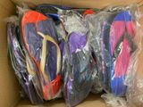 several pairs of shoes are in a box wrapped in plastic