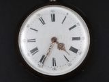 a close up of a pocket watch with roman numerals on it