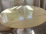 a marble table and chairs in a room