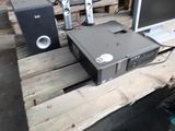 a computer sitting on top of a pallet next to speakers