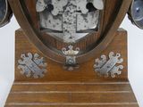 a clock that is on a wooden stand on a white background