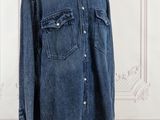 an image of a denim shirt on a mannequin stand