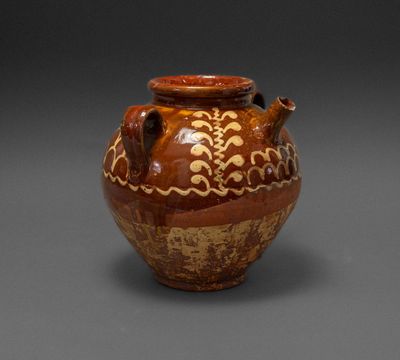 brown and white vase on grey background with brown and white decoration