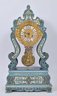 a blue and gold clock sitting on top of a table