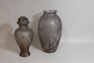 two vases sitting next to each other on a white surface