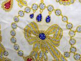 an image of a close up of a white cloth with gold and blue designs
