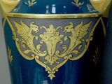 a large blue vase with gold decoration on it