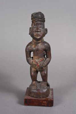 statue of a man holding a bowl of fruit on a wooden base