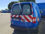 a blue van that is parked in a parking lot