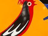 a clock with a bird painted on the side of it