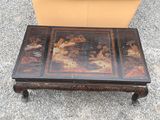 a coffee table with a painting on the top of it