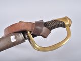 a close up of a sword with a brass handle