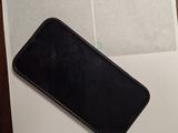 a black cell phone sitting on top of a piece of paper