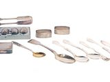 a lot of spoons and spoon knives on the table
