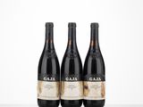 three bottles of wine sitting on top of a table next to each other