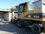 a picture of a construction vehicle parked in front of a building
