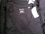 a pile of t - shirts with the word rugby on them