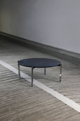 a black table sitting on a wooden floor in a room