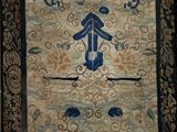 an image of a blue and beige oriental rug with a man on a horse