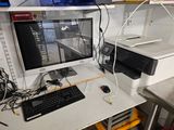 a desk with a computer and a printer on it
