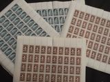 four different types of postage stamps are laid out on a table