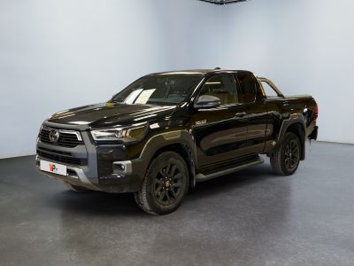 the black toyota tunder is parked in a large room