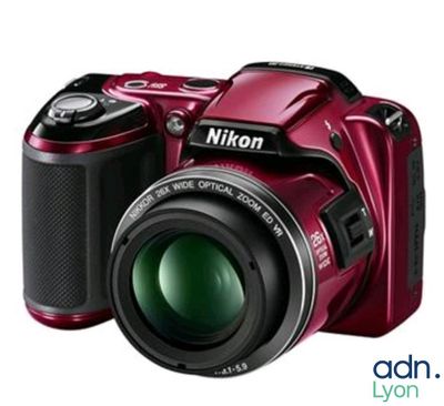 the camera is red and has a green lens on it